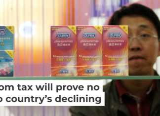 A Chinese visitor looks at condoms at the Beijing International Sex Supplies Exhibition. Zhang Peng/LightRocket via Getty Images